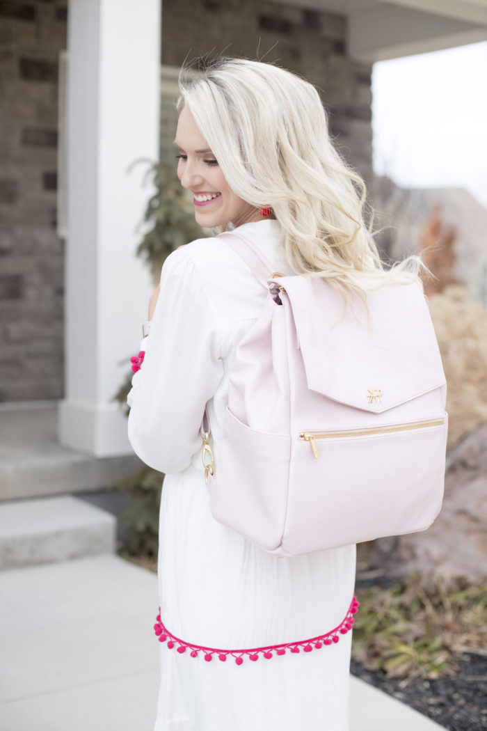 Freshly Picked discount code featured by top Utah life and style blog, A Slice of Style: image of a woman holding a pink Freshly Picked diaper bag