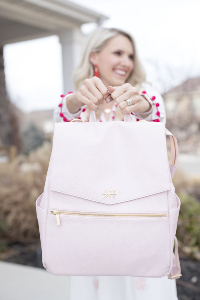 Freshly Picked discount code featured by top Utah life and style blog, A Slice of Style: image of a woman holding a pink Freshly Picked diaper bag