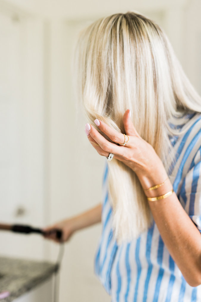 How to Curl Long Hair FAST & Keep your Hair Healthy featured by top Utah beauty blog, A Slice of Style: image of a woman holding a curling wand