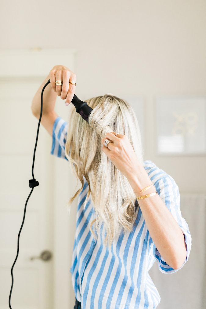 How to Curl Long Hair FAST & Keep your Hair Healthy featured by top Utah beauty blog, A Slice of Style: image of a woman holding a curling wand