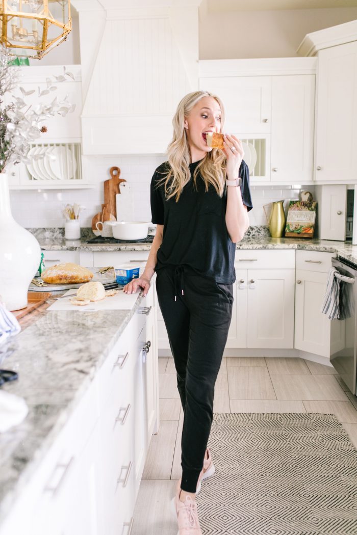 Most Popular Products featured by top US life and style blog A Slice of Style; Image of a woman wearing Nike shoes, black shirt and black joggers.