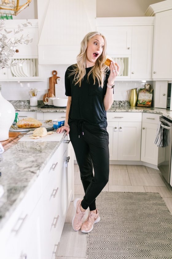 Most Popular Products featured by top US life and style blog A Slice of Style; Image of a woman wearing Nike shoes, black shirt and black joggers.