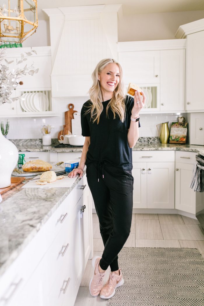 Most Popular Products featured by top US life and style blog A Slice of Style; Image of a woman wearing Nike shoes, black shirt and black joggers.