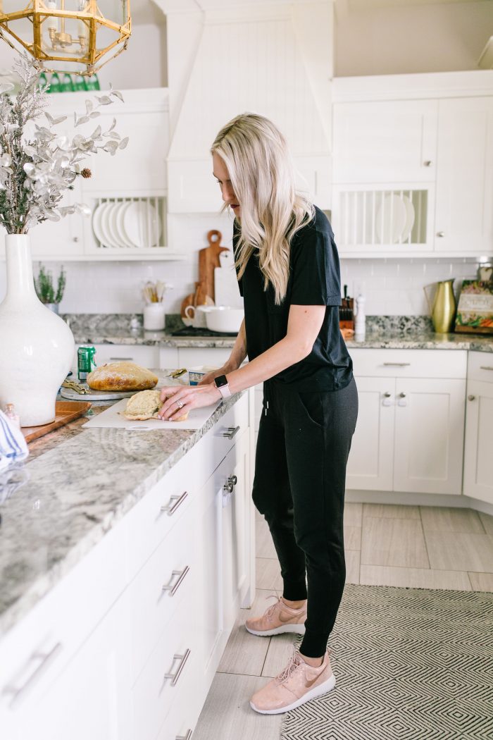 Most Popular Products featured by top US life and style blog A Slice of Style; Image of a woman wearing Nike shoes, black shirt and black joggers.