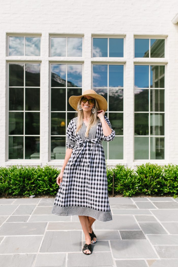 J Crew Summer Style featured by top US life and style blog, A Slice of Style: image of a woman wearing a J crew gingham button up dress, J crew leather sandals, J Crew raffia statement earrings, J Crew straw hat and J Crew oversized sunglasses