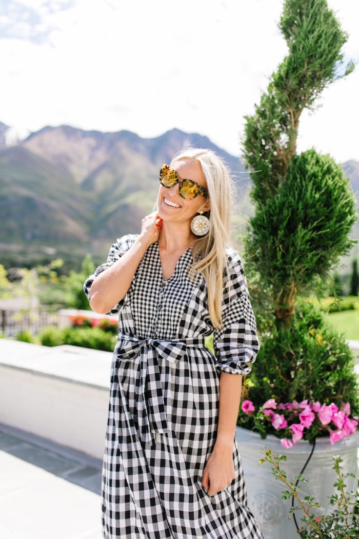 J Crew Summer Style featured by top US life and style blog, A Slice of Style: image of a woman wearing a J crew gingham button up dress, J crew leather sandals, J Crew raffia statement earrings, J Crew straw hat and J Crew oversized sunglasses