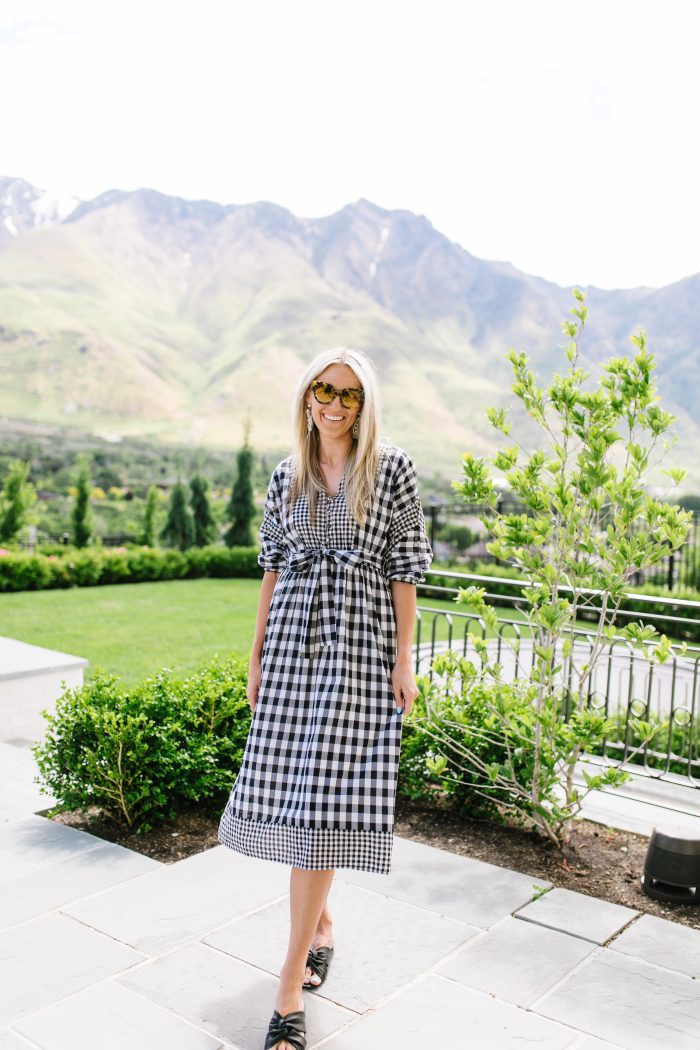 J Crew Summer Style featured by top US life and style blog, A Slice of Style: image of a woman wearing a J crew gingham button up dress, J crew leather sandals, J Crew raffia statement earrings, J Crew straw hat and J Crew oversized sunglasses