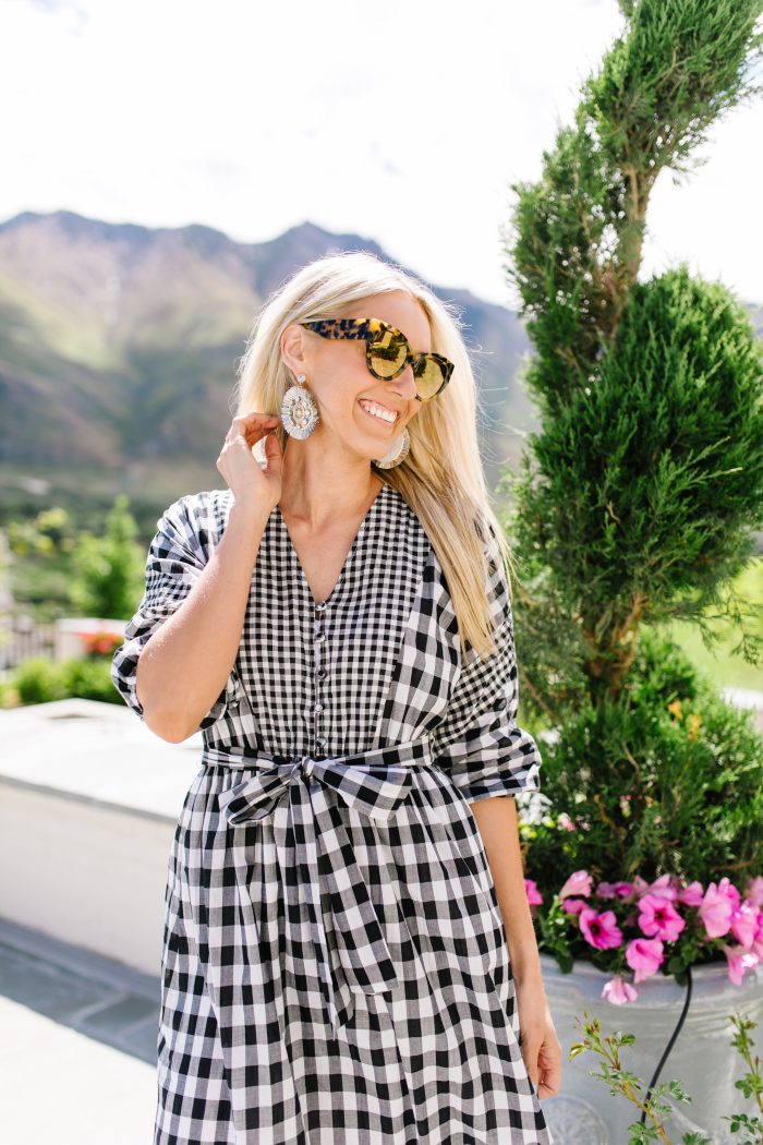 J Crew Summer Style featured by top US life and style blog, A Slice of Style: image of a woman wearing a J crew gingham button up dress, J crew leather sandals, J Crew raffia statement earrings, J Crew straw hat and J Crew oversized sunglasses