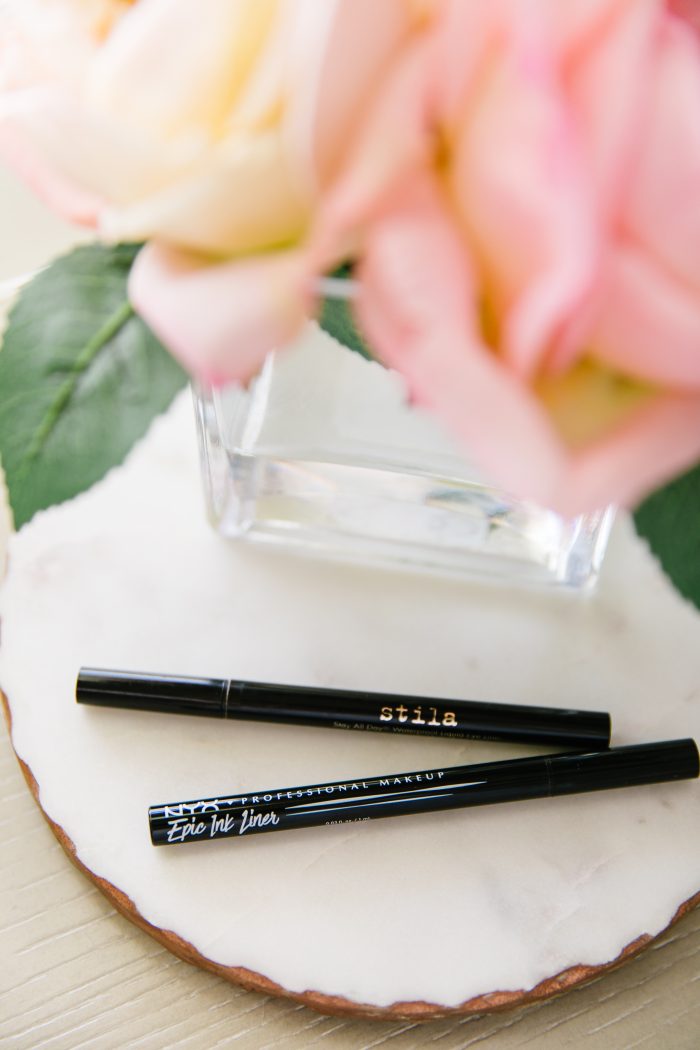 Affordable Amazon Beauty Dupes + Latest Amazon Favorites! by popular Utah beauty blog, A Slice of Style: image of Stilla and NYX black in eyeliner next to a small vase of roses.