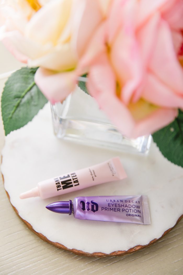 Affordable Amazon Beauty Dupes + Latest Amazon Favorites! by popular Utah beauty blog, A Slice of Style: image of liquid Urban Decay and Thank Me Later liquid eyeshadow next to a small vase of roses.