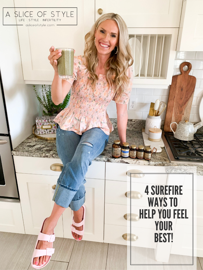 Solgar Vitamins Review + Green Smoothie Recipe by popular Utah life and style blog, A Slice of Style: image of a woman sitting on her kitchen counter next to various bottle of Solgar vitamins and holding a green smoothie in a clear tumbler cup.