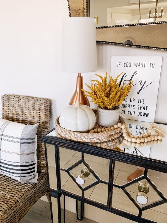 My Home Decorated for Fall! by popular Utah lifestyle blog, A Slice of Style: image of a entry table decorated with white Home Depot Three Hands ceramic vases and a Threshold 11" x 10" Artificial Goldenrod Arrangement in Ceramic Pot from Target.