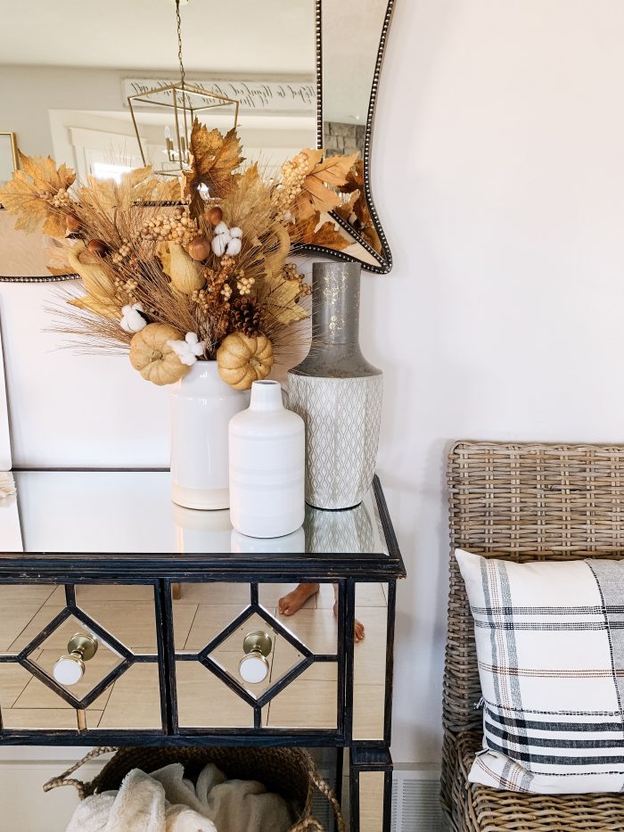 My Home Decorated for Fall! by popular Utah lifestyle blog, A Slice of Style: image of a entry table decorated with white Home Depot Three Hands ceramic vases and a Threshold 11" x 10" Artificial Goldenrod Arrangement in Ceramic Pot from Target.