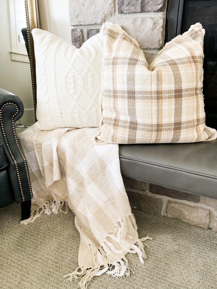 My Home Decorated for Fall! by popular Utah lifestyle blog, A Slice of Style: image of a fireplace mantle decorated with Target Threshold cream Decorative Ceramic Pumpkins, Target Threshold Plaid Cotton Throw Blanket, Target Threshold Cable Knit Chenille Throw Pillow, and Etsy Crateful Studio Chunky Knit Blanket.