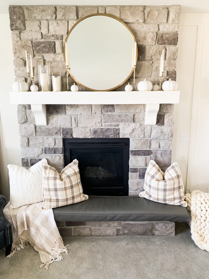 My Home Decorated for Fall! by popular Utah lifestyle blog, A Slice of Style: image of a fireplace mantle decorated with Target Threshold cream Decorative Ceramic Pumpkins, Target Threshold Plaid Cotton Throw Blanket, Target Threshold Cable Knit Chenille Throw Pillow, and Etsy Crateful Studio Chunky Knit Blanket.