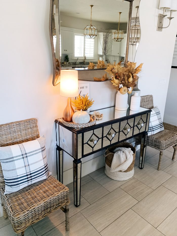 My Home Decorated for Fall! by popular Utah lifestyle blog, A Slice of Style: image of a entry table decorated with white Home Depot Three Hands ceramic vases and a Threshold 11" x 10" Artificial Goldenrod Arrangement in Ceramic Pot from Target.