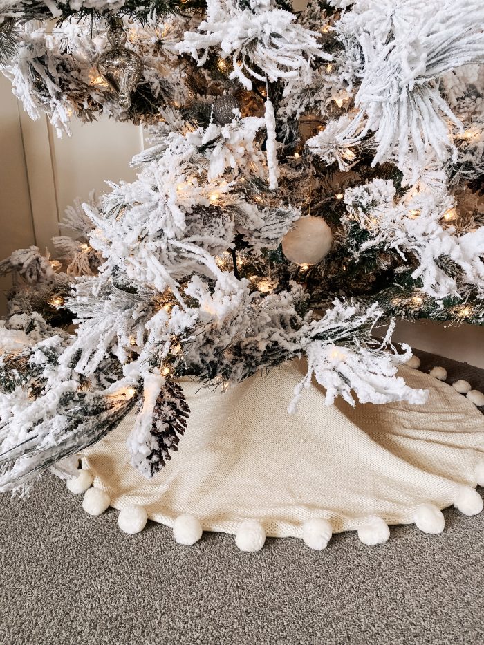 White Christmas decor featured by top US life and style blog, A Slice of Style | My White Christmas Home Decor: Some Items Under $10! by popular Utah lifestyle blog, A Slice of Style: image of a Wayfair Flocked Long Needle Green Pine Tree Artificial Christmas Tree with a 48" Pompom Christmas Tree Skirt.