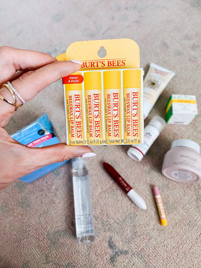 Walmart Beauty Products by popular Utah beauty blog, A Slice of Style: image of a woman holding a Walmart Burt's Bees Beeswax Lip Balm 4 pack. 