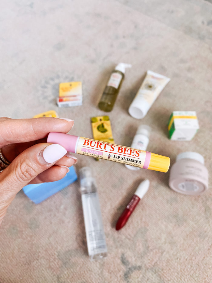 Walmart Beauty Products by popular Utah beauty blog, A Slice of Style: image of a woman holding a Walmart Burt's Bees lip shimmer. 