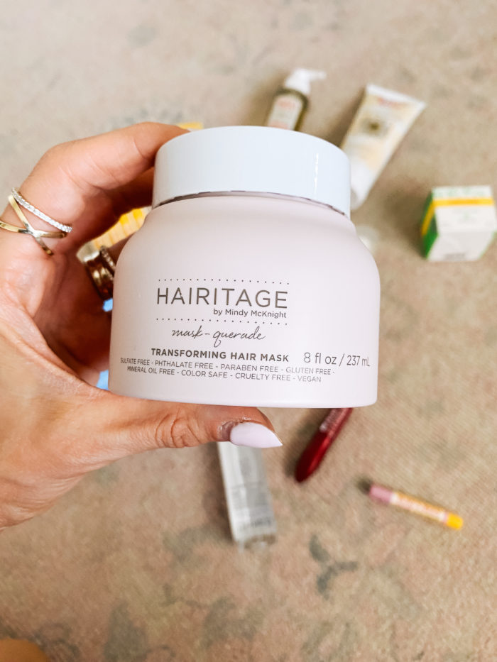 Walmart Beauty Products by popular Utah beauty blog, A Slice of Style: image of a woman holding a jar of Walmart Hairitage mask-querade hair mask. 