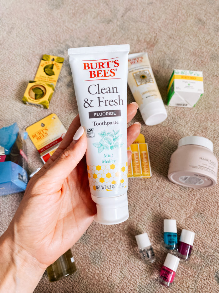 Walmart Beauty Products by popular Utah beauty blog, A Slice of Style: image of a woman holding a tube of Walmart Burt's Bees clean and fresh toothpaste.