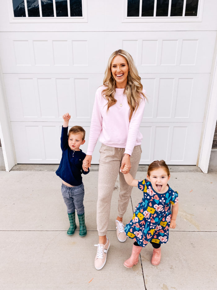 Amazon haul by popular Utah fashion blog, A Slice of Style: image of a woman wearing a Amazon Hanes Women's V-Notch Pullover Fleece Sweatshirt, tan joggers, and Amazon Tommy Hilfiger Women's Fentii Sneaker and holding hands with her daughter who is wearing a Amazon Simple Joys by Carter's Baby and Toddler Girls' 2-Pack Short-Sleeve and Sleeveless Dress Sets.