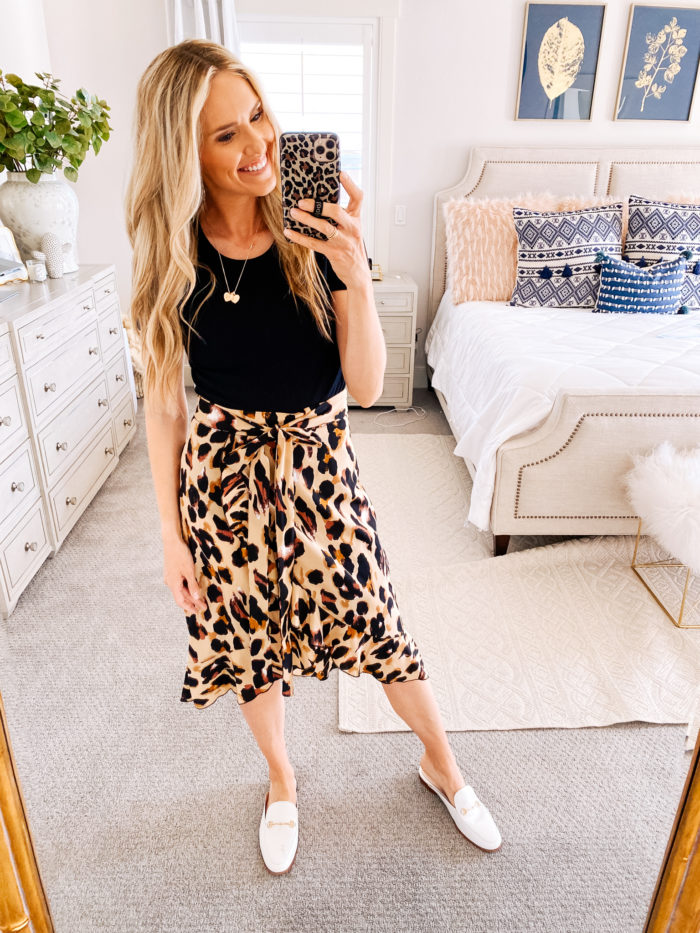 Amazon haul by popular Utah fashion blog, A Slice of Style: image of a woman wearing a Amazon IEFSHINY Heart Initial Necklace for Women, Amazon SheIn Women's Leopard Print Ruffle Hem Casual Midi Wrap Skirt and Amazon Sam Edelman Women's Linnie Mule.