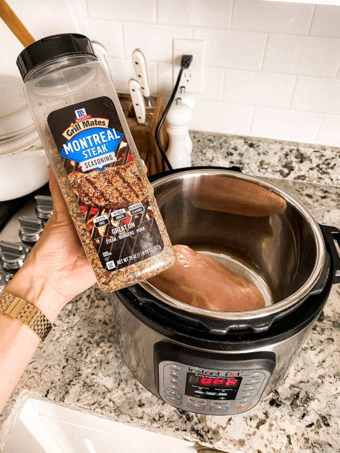 instant pot chicken | Instant Pot Chicken by popular Utah lifestyle blog, A Slice of Style: image of chicken in a Instant Pot and a woman holding Grill Mates Montreal Steak seasoning. 