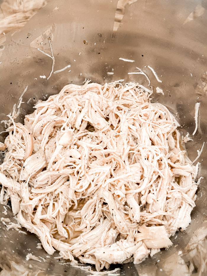 instant pot chicken | Instant Pot Chicken by popular Utah lifestyle blog, A Slice of Style: image of shredded chicken in an Instant Pot. 