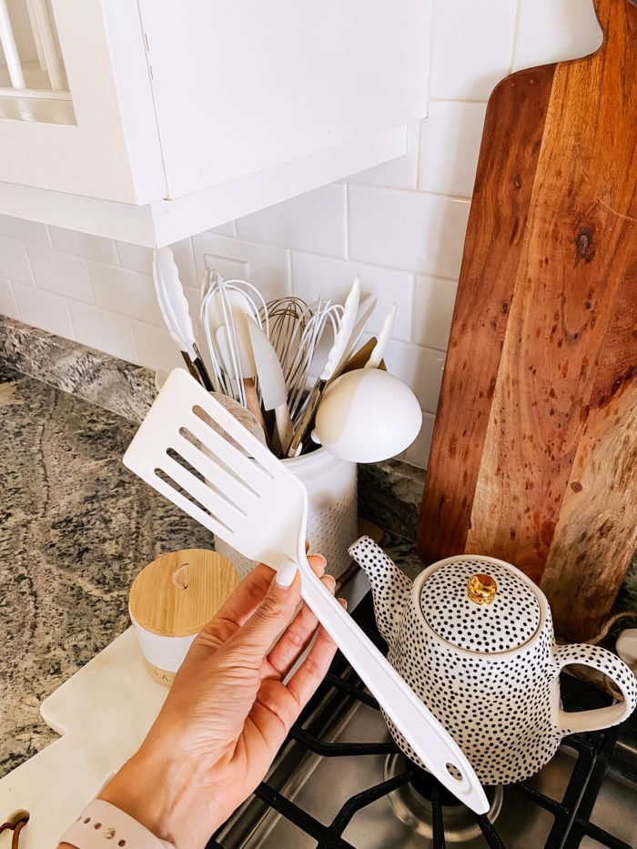 Best Kitchen Tools by popular Utah lifestyle blog, A Slice of Style: image of a Jenica Parcell holding a white plastic spatula. 