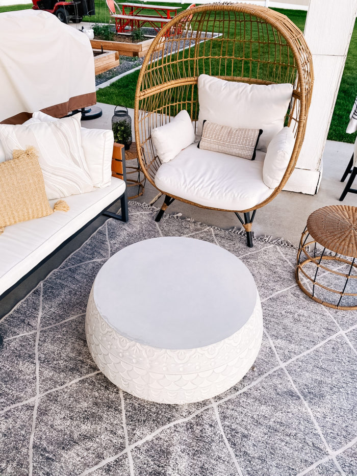 White Outdoor Cushions by popular Utah life and style blog, A Slice of Style: image of a backyard patio with bistro lights, patio furniture and white outdoor cushions. 