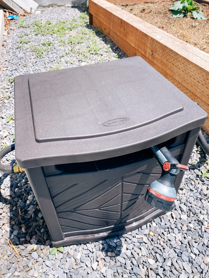 White Outdoor Cushions by popular Utah life and style blog, A Slice of Style: image of a garden hose reel. 