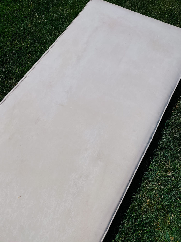 White Outdoor Cushions by popular Utah life and style blog, A Slice of Style: image of a wet white outdoor cushion. 