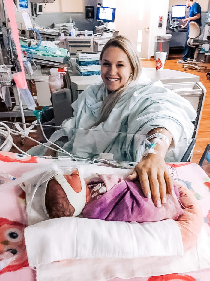 4th Birthday Party by popular Utah motherhood blog, A Slice of Style: image of Jenica Parcell sitting by her newborn baby in the hospital. 
