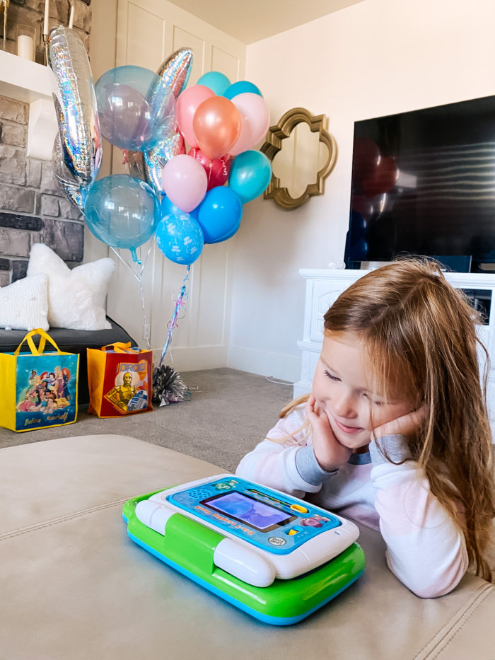 4th Birthday Party by popular Utah motherhood blog, A Slice of Style: image of a little girl playing with a Leap Frog electronic toy. 