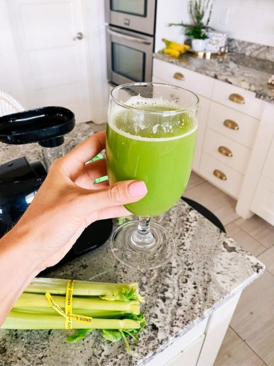 Epstein-Barr | Epstein-Barr Virus by popular Utah lifestyle blog, A Slice of Style: image of a woman holding a glass of celery juice. 