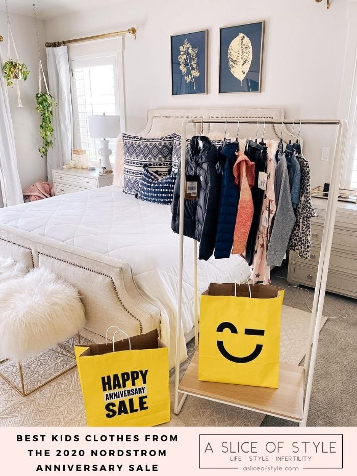 Nordstrom Anniversary Sale by popular Utah fashion blog, A Slice of Style : image of Nordstrom kids' clothes hanging on a clothing wrack that's next to some Nordstrom Anniversary Sale shopping bags. 