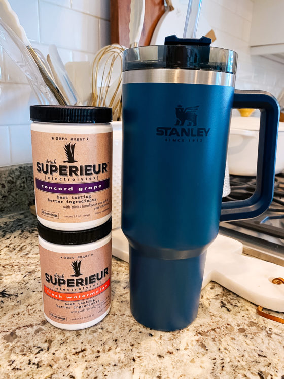 Stanley Travel Mug by popular Utah lifestyle blog, A Slice of Style: image of a blue Stanley travel mug next to Superieur electrolytes powder. 
