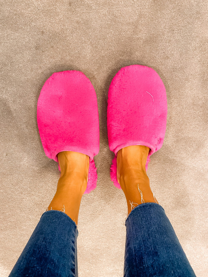 Nordstrom Anniversary Sale by popular Utah fashion blog, A Slice of Style: image of Jenica Parcell wearing distressed denim and pink UGG slippers. 